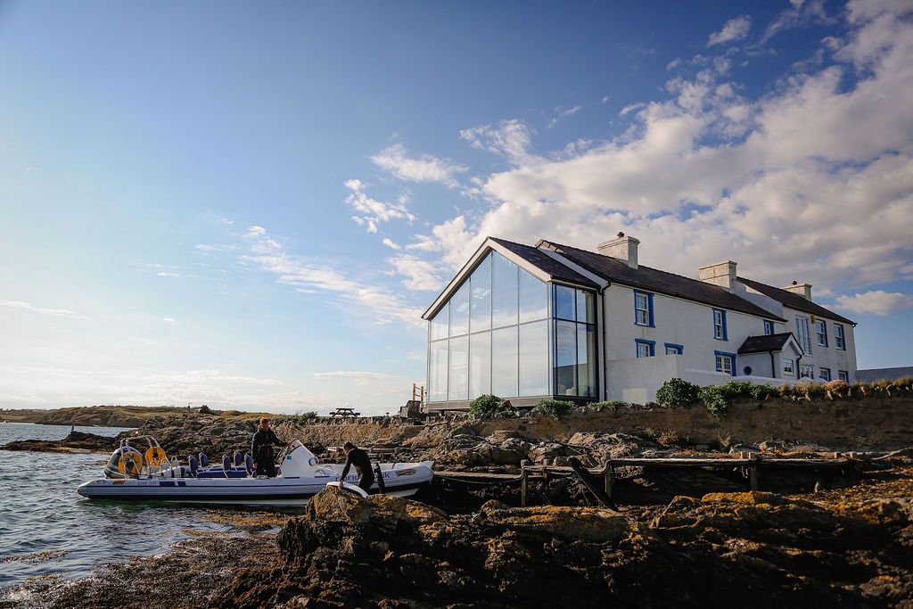 Hen Cymyran, a glass-fronted holiday house on the shore at Cymyran Beach, Anglesey