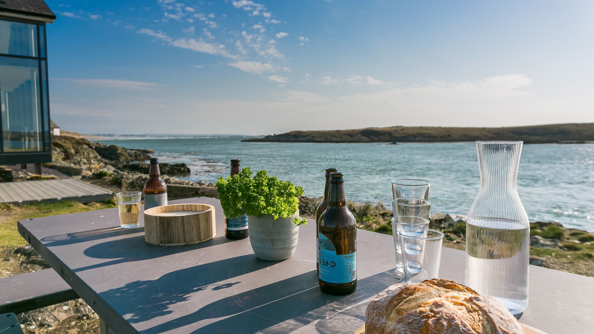 The hot tub on the terrace at Hen Cymyran looking out across the water