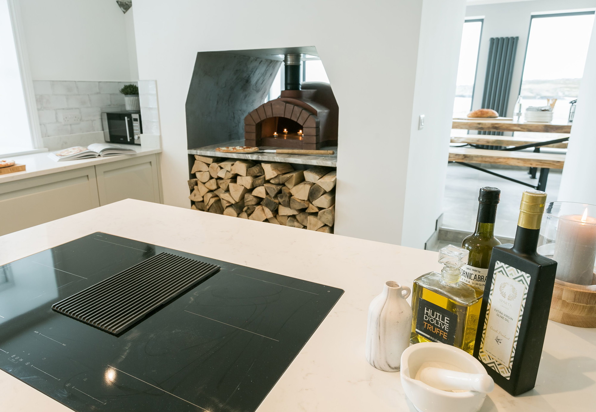 The sociable kitchen with wood-fired pizza oven and stacked logs