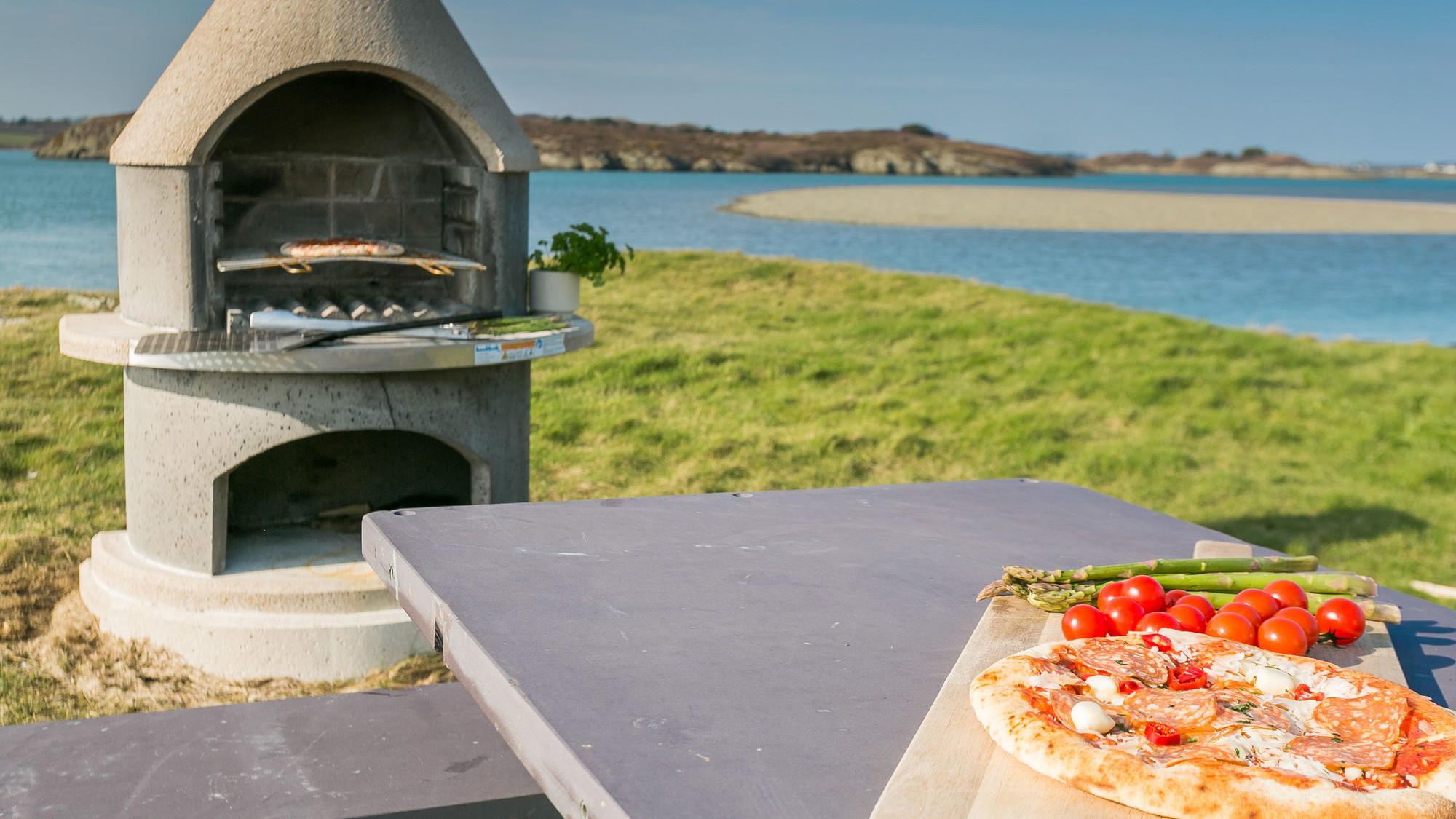 Outdoor pizza oven and slate table on the headland by the sea